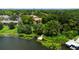 Scenic aerial view of the lakefront with a wooden dock, surrounding trees and homes at 818 Park Lake Cir # 10, Maitland, FL 32751
