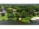 Aerial view of the lakefront property with a dock, lush greenery, and nearby residences at 818 Park Lake Cir # 10, Maitland, FL 32751