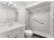 Bright bathroom featuring a tiled shower with safety bar, modern vanity, and neutral decor at 818 Park Lake Cir # 10, Maitland, FL 32751