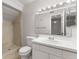 Bathroom featuring a tiled shower, vanity, and neutral decor at 818 Park Lake Cir # 10, Maitland, FL 32751