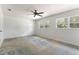 Bright bedroom with ceiling fan, carpet, and two windows for natural light at 818 Park Lake Cir # 10, Maitland, FL 32751