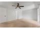 Spacious bedroom with ceiling fan, two doors, and neutral carpet and walls at 818 Park Lake Cir # 10, Maitland, FL 32751