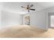 Bedroom features a ceiling fan, carpet, and sliding glass doors to a balcony at 818 Park Lake Cir # 10, Maitland, FL 32751