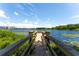 Scenic dock overlooking the lake with natural landscaping and water lilies at 818 Park Lake Cir # 10, Maitland, FL 32751