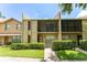 Attractive condo with tan exterior, well-manicured lawn, and screened in porch at 818 Park Lake Cir # 10, Maitland, FL 32751