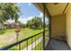View from balcony showing a lush green community space and walkway, with a small table on the patio at 818 Park Lake Cir # 10, Maitland, FL 32751