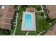 Aerial view of a sparkling community pool with lounge chairs surrounded by lush landscaping and buildings at 818 Park Lake Cir # 10, Maitland, FL 32751