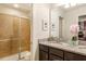Bathroom features double sinks with granite counters and glass enclosed shower at 8801 Corcovado Dr, Kissimmee, FL 34747