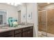 Bathroom boasts granite counters, dual sinks, decorative vases and glass enclosed shower at 8801 Corcovado Dr, Kissimmee, FL 34747