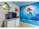 Charming bedroom featuring a Little Mermaid theme mural, perfect for creating a whimsical space at 8801 Corcovado Dr, Kissimmee, FL 34747