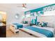 Bright bedroom features two beds with decorative pillows and a unique geometric accent wall at 8801 Corcovado Dr, Kissimmee, FL 34747
