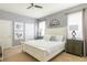 Bright bedroom features a white bed, textured walls, and ample natural light through the large windows at 8801 Corcovado Dr, Kissimmee, FL 34747