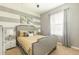 Stylish bedroom features a modern bed, striped walls, and plenty of natural light from the window at 8801 Corcovado Dr, Kissimmee, FL 34747