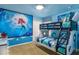 Whimsical bedroom with custom bunk beds, nautical decor, and a vibrant mural creating a fun atmosphere at 8801 Corcovado Dr, Kissimmee, FL 34747