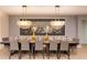Elegant dining room with a long wooden table, seating for twelve, and decorative light fixtures at 8801 Corcovado Dr, Kissimmee, FL 34747