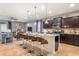 Bright kitchen featuring dark cabinetry, a large island with seating, and stainless steel appliances at 8801 Corcovado Dr, Kissimmee, FL 34747