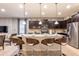 Stylish kitchen island with counter seating, pendant lighting, and modern appliances at 8801 Corcovado Dr, Kissimmee, FL 34747