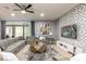 Comfortable living room featuring a large sectional sofa, modern decor, and a stylish geometric wall design at 8801 Corcovado Dr, Kissimmee, FL 34747