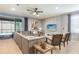 Spacious living room features comfortable seating, a ceiling fan, and sliding doors to the pool area at 8801 Corcovado Dr, Kissimmee, FL 34747