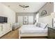 Bright primary bedroom features a white bed, textured walls, and ample natural light through the large windows at 8801 Corcovado Dr, Kissimmee, FL 34747