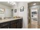 Bathroom featuring granite countertop vanity, framed mirror, and a shower at 8801 Macapa Dr, Kissimmee, FL 34747