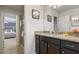Bathroom featuring granite countertop vanity, framed mirror, and a shower at 8801 Macapa Dr, Kissimmee, FL 34747