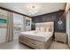 Bedroom with a luxurious bed, decorative lighting, and stylish patterned wallpaper at 8801 Macapa Dr, Kissimmee, FL 34747