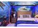 Ocean-themed bedroom with a king size bed, unique bedside table and blue lighting at 8801 Macapa Dr, Kissimmee, FL 34747