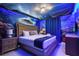 Ocean-themed bedroom with a king size bed, unique bedside table and blue lighting at 8801 Macapa Dr, Kissimmee, FL 34747