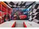 Themed bedroom featuring custom beds and murals of popular race car movies at 8801 Macapa Dr, Kissimmee, FL 34747