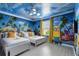 Bright and cheerful 'Minions' themed bedroom with twin beds, vibrant mural, and playful decor at 8801 Macapa Dr, Kissimmee, FL 34747