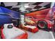 Themed bedroom featuring custom beds and murals of popular race car movies at 8801 Macapa Dr, Kissimmee, FL 34747