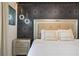 Bedroom with a luxurious bed, decorative lighting, and stylish patterned wallpaper at 8801 Macapa Dr, Kissimmee, FL 34747