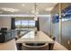 Modern dining room featuring an extra long table, stylish light fixture, and view of backyard pond at 8801 Macapa Dr, Kissimmee, FL 34747