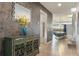 Inviting entryway with stylish console table, decorative mirror, and view into the dining area at 8801 Macapa Dr, Kissimmee, FL 34747