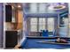 The game room features a pool table, a bar area, a dining table and Star Wars theming at 8801 Macapa Dr, Kissimmee, FL 34747