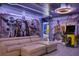Spacious, Star Wars themed game room featuring a comfortable sectional sofa and Pac-Personal arcade game at 8801 Macapa Dr, Kissimmee, FL 34747