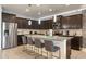 Well-equipped kitchen with dark cabinetry, stainless steel appliances, and granite countertops at 8801 Macapa Dr, Kissimmee, FL 34747