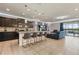 Contemporary kitchen and living space with modern countertops, stainless appliances, and breakfast bar at 8801 Macapa Dr, Kissimmee, FL 34747