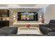 Living room with a feature wall and large television, open to the kitchen area at 8801 Macapa Dr, Kissimmee, FL 34747