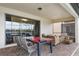Covered patio has comfortable seating with views of the pool and lush backyard at 8801 Macapa Dr, Kissimmee, FL 34747