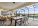 Covered patio featuring ample seating and a scenic view of the pool and lake at 8801 Macapa Dr, Kissimmee, FL 34747
