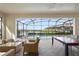 Relaxing screened-in patio with wicker seating and a pool view at 8801 Macapa Dr, Kissimmee, FL 34747