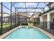 Private screened-in pool and spa with peaceful views of the manicured backyard at 8801 Macapa Dr, Kissimmee, FL 34747
