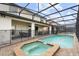 Tranquil screened-in pool and spa area, perfect for relaxation and enjoying the scenery at 8801 Macapa Dr, Kissimmee, FL 34747