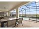 Inviting screened-in patio offering a private pool and spa with scenic water views at 8801 Macapa Dr, Kissimmee, FL 34747
