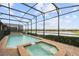 Backyard pool and spa area enclosed in a screen with views of the surrounding community at 8801 Macapa Dr, Kissimmee, FL 34747