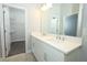 A bright, tiled bathroom with a double sink vanity and a walk-in closet at 922 Wild Date Ln, Lake Mary, FL 32746