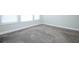 A bedroom features bright, natural lighting, light gray walls, and soft carpeting at 922 Wild Date Ln, Lake Mary, FL 32746