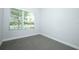 Cozy bedroom with a large window and neutral carpeting at 922 Wild Date Ln, Lake Mary, FL 32746
